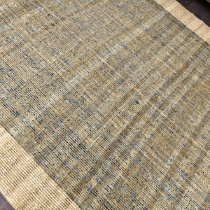 Handwoven area rug featuring geometric color blocks in rich navy blue, warm golden yellow, olive green and natural beige tones. This modern Turkish kilim style rug has a textured flat weave with white fringe edges, perfect for bohemian or Scandinavian interiors. Natural fiber construction creates an eco-friendly floor covering.
