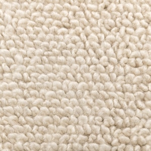 May include: Close-up of a cream-coloured, textured rug with a soft, fluffy surface.