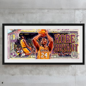 May include: A framed artwork featuring a basketball player in a Lakers jersey, holding a basketball. The artwork has a dollar bill design with the name "Kobe Bryant" in large letters. The color scheme includes yellow, purple, and black.