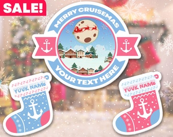 May include: A blue and pink Christmas stocking with a white anchor and the text "YOUR NAME" on it. The stocking is decorated with a white snowflake pattern. The background is a blurred image of a winter scene with a red sleigh flying through the air.