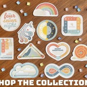 May include: A collection of colorful stickers with various designs, including a rainbow, a unicorn, and an infinity symbol. The stickers feature text related to breathing exercises and mindfulness. The phrase "SHOP THE COLLECTION!" is at the bottom.