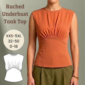 Puede incluir: Un top sin mangas naranja con fruncido bajo el busto. La parte superior sin mangas presenta un diseño fruncido debajo del busto y un cuello redondo. La imagen también incluye una pequeña ilustración del top y el texto "Ruched Underbust Tank Top" y "XXS-5XL 32-50 0-18".