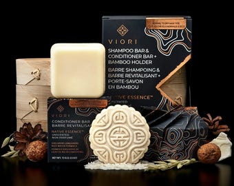 May include: A Viori Native Essence set featuring a shampoo bar, a conditioner bar with an intricate embossed pattern, and a bamboo holder. The black packaging displays the text Viori, Shampoo Bar & Conditioner Bar + Bamboo Holder, and Net Wt. 72 g (2.53 oz).
