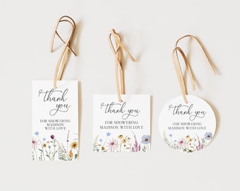 May include: Three white thank you tags with a floral design and the text "Thank you" and "For showering Madison with love".