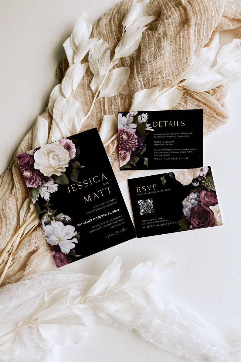 May include: Black wedding invitation suite with floral designs. The invitation features the names Jessica and Matt, the date Saturday October 31, 20XX, and the time 6 o'clock in the evening. The RSVP card includes a QR code and the website WEDDING WEBSITE.COM.