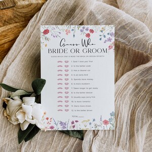 May include: A printable bridal shower game card with a floral border. The card has the title "Guess Who Bride or Groom" and a list of 12 questions to determine who is more like the bride or groom.