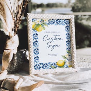 May include: White frame with a blue and white tiled pattern and lemons. The text "Fully Editable Custom Sign" and "Add your own text here" is on a white background.