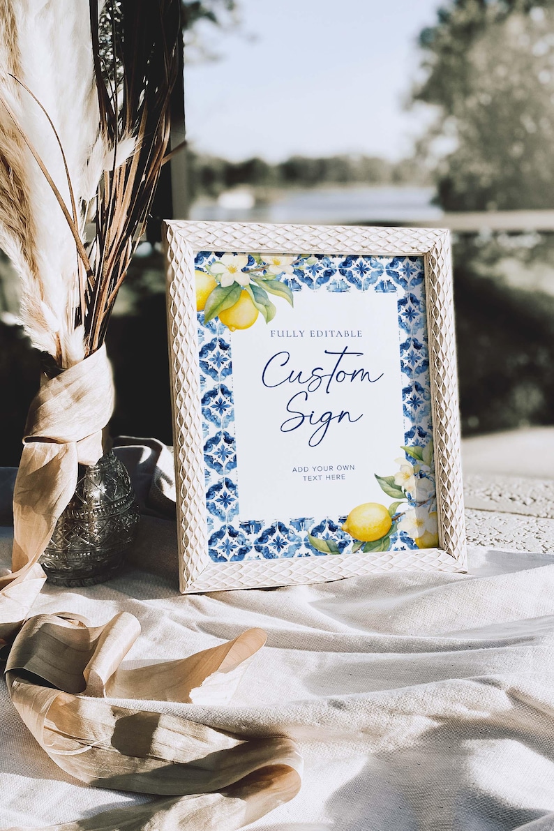 May include: White frame with a blue and white tiled pattern and lemons. The text "Fully Editable Custom Sign" and "Add your own text here" is on a white background.