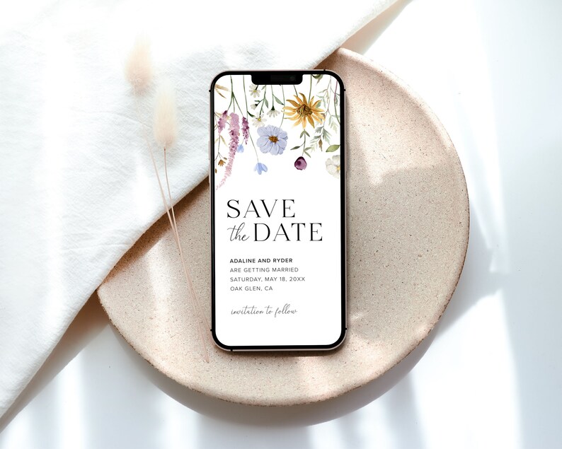 May include: A digital save the date card with a floral design. The text reads "Save the Date" with the names "Adaline and Ryder" and the wedding date "Saturday, May 18, 20XX". The location is "Dak Glen, CA".