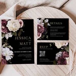 May include: Black wedding invitation suite with floral designs in shades of burgundy, white, and green. The text on the invitation reads "Jessica and Matt" and includes the date and time of the wedding. The RSVP card includes a QR code. The details card includes the venue and website.