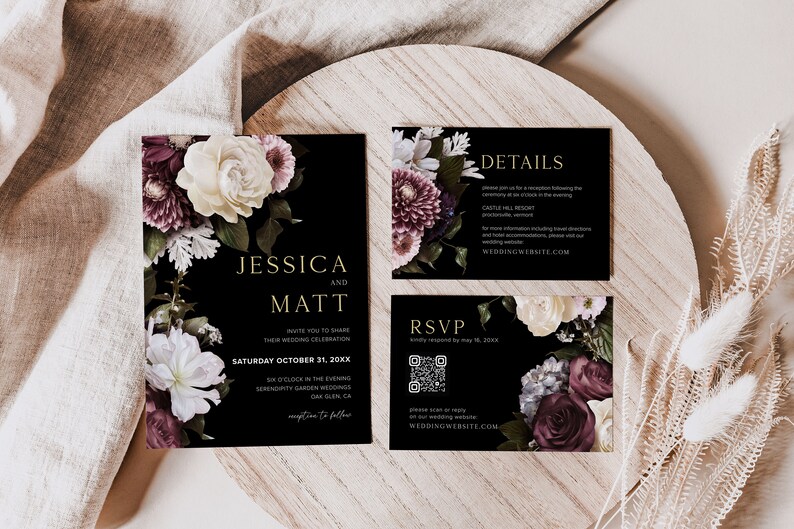 May include: Black wedding invitation suite with floral designs in shades of burgundy, white, and green. The text on the invitation reads "Jessica and Matt" and includes the date and time of the wedding. The RSVP card includes a QR code. The details card includes the venue and website.