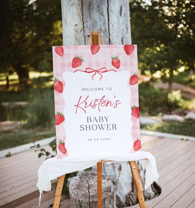 May include: A pink and white gingham welcome sign with red strawberries and the text "Welcome to Kristen's Baby Shower 08.20.20XX".