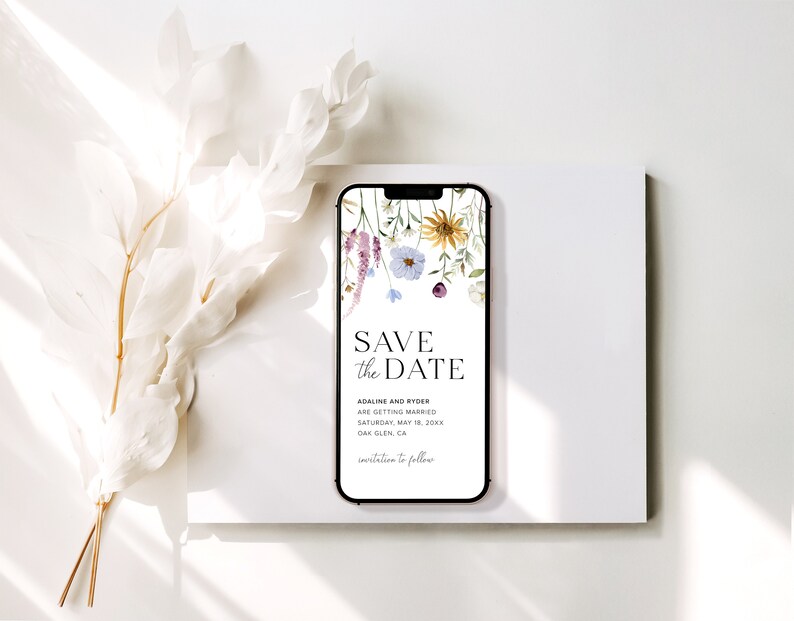 May include: A smartphone mockup displaying a save the date card with a floral design. The text reads "Save the Date", "Adaline and Ryder are getting married", "Saturday, May 18, 20XX", "Oak Glen, CA", and "Invitation to follow".