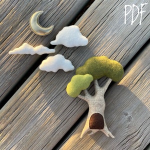 May include: A felt craft kit for making a tree, clouds, and a crescent moon. The kit includes felt pieces in green, brown, and white, as well as a gold moon.