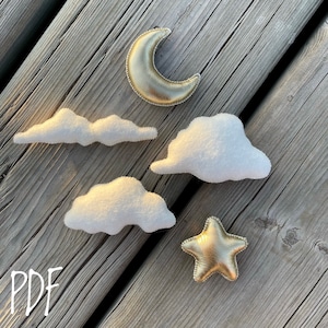 Może przedstawiać: Zestaw wzorów do rękodzieła z filcu do wykonania księżyca, gwiazdy i chmur. Wzory są wydrukowane na białym papierze czarnym tuszem i zawierają napis "PDF".