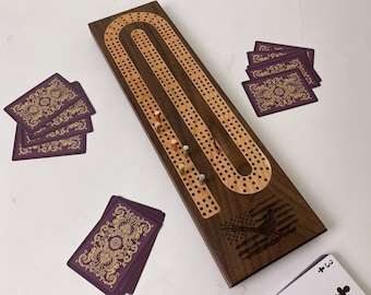 May include: A wooden cribbage board with a curved track and a pheasant design. The board is made of walnut wood and has a natural finish. The track is made of maple wood and has a light brown finish. The board is 24 inches long and 6 inches wide. The board comes with 12 pegs and a set of playing cards.