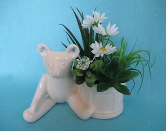 Vintage planter, teddy bear next to drum, 267