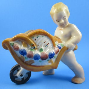 Vintage windowsill planter, small cherub like boy pushing cart