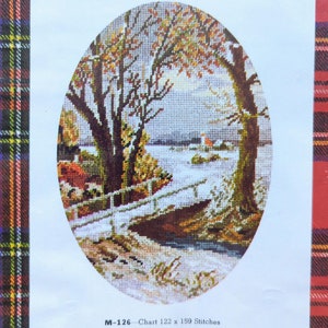 May include: A cross-stitch pattern featuring a winter scene with a bridge, trees, and a river. The pattern is oval shaped and has a white background with colorful details. The text "M-126 - Chart 122 x 159 Stitches" is printed below the pattern.