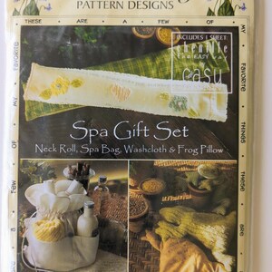 May include: A package for a Spa Gift Set with the text "Favorite Things Pattern Designs". The package includes images of a neck roll, spa bag, washcloth, and frog pillow. The package is in a clear plastic sleeve.