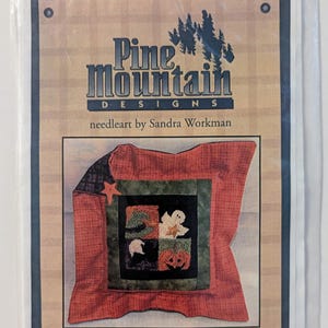 May include: A Pine Mountain Designs needleart kit by Sandra Workman titled P14 Halloween 4 Patch. The package includes pre-printed fabric for a punch needle design with a finished size of approximately 3 inches by 3 inches, featuring a ghost, pumpkin, and witch hat.