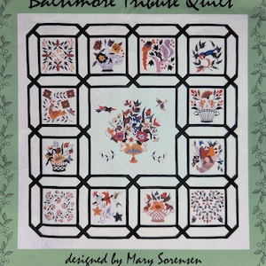 May include: A white quilt with a black grid design, featuring floral and bird motifs in various colors. The quilt is titled "Baltimore Tribute Quilt" and designed by Mary Sorensen. Pattern #17, ©1993 M. K. Sorensen.