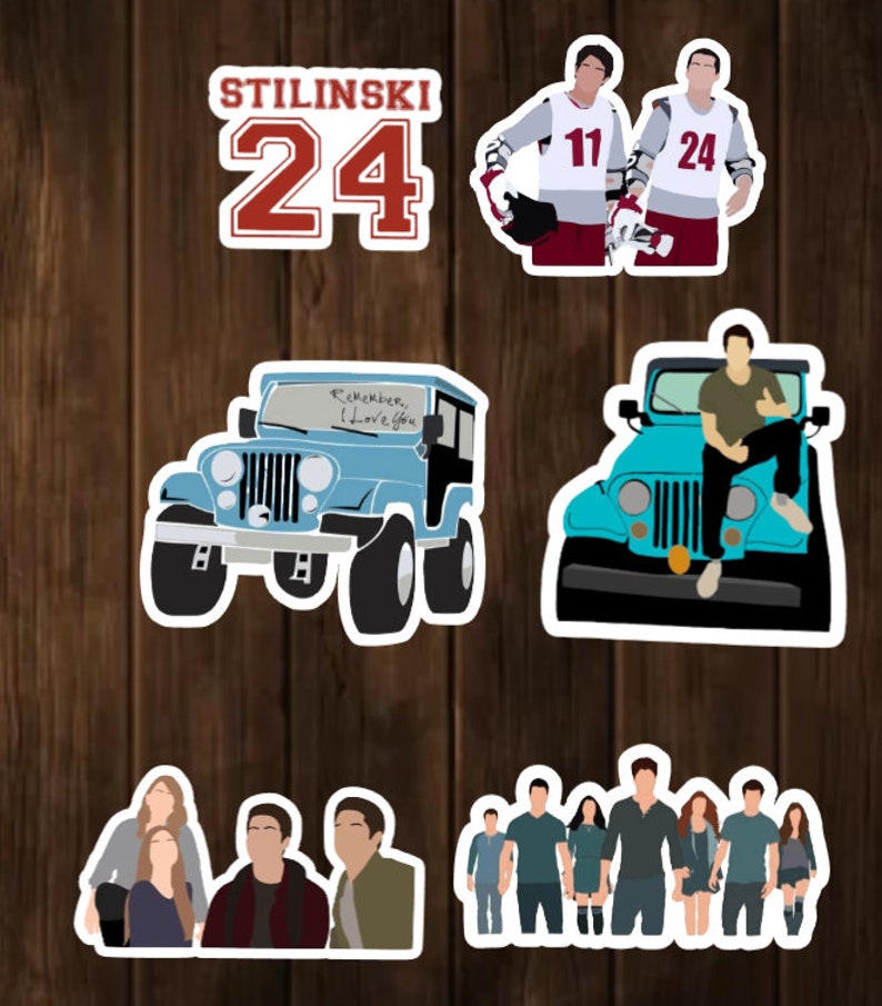 May include: A set of stickers featuring characters and objects from the popular TV show Teen Wolf. The stickers include a blue Jeep with the words "Remember I Love You" written on the windshield, a group of characters standing together, two characters wearing hockey jerseys with the numbers 11 and 24, and a character sitting on a blue Jeep.