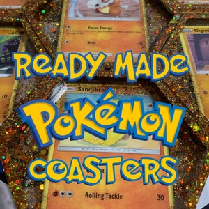 May include: Ready-made Pokemon coasters featuring a gold glitter resin with Pokemon cards embedded inside. The cards include Cubone, Diglett, and Sandsrew. The text "READY MADE POKEMON COASTERS" is printed on the resin.