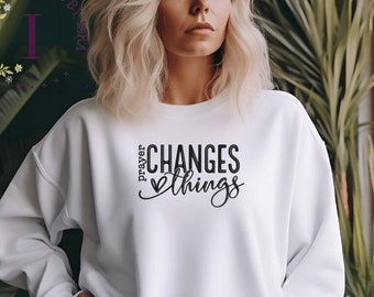 Sudadera unisex inspiradora con la frase "La oración cambia las cosas" bordada