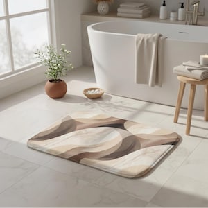 May include: A rectangular bath mat with a wavy pattern in shades of beige, brown, and cream. The mat is placed on a white tiled floor in a bathroom setting, with a bathtub and other bathroom accessories visible in the background.