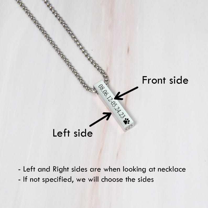 May include: Silver necklace with a rectangular pendant engraved with the date "08.06.12-05.24.23" and a paw print. The pendant is on a silver chain.