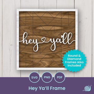 May include: A white wooden frame with a brown woodgrain background. The text "hey ya'll" is written in white cursive font. The frame has a geometric pattern of black lines. A blue starburst sticker says "Round & Diamond Frames Also Included".