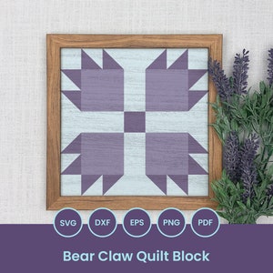 Pode incluir: Um bloco de colcha emoldurado com um design de garra de urso. O bloco de colcha é feito de tecido roxo e azul e é colocado sobre um fundo branco. A moldura é de madeira e tem um acabamento marrom claro. O texto "Bear Claw Quilt Block" é impresso abaixo da imagem.