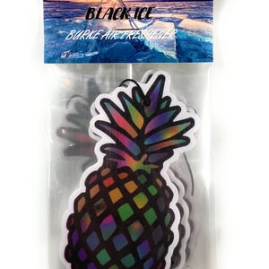 May include: Air fresheners in a clear plastic package. The air fresheners are pineapple-shaped with a rainbow design. The package has the words "BLACK ICE" and "BURKE AIR FRESHENER" printed on it, with a background image of an icy landscape.