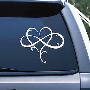 May include: White vinyl decal of an infinity symbol intertwined with a heart shape. The design is intricate and features a swirling pattern.