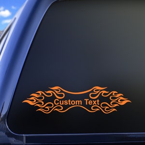 May include: Orange flame decal with a banner that says "Custom Text" for a car window or other smooth surface.