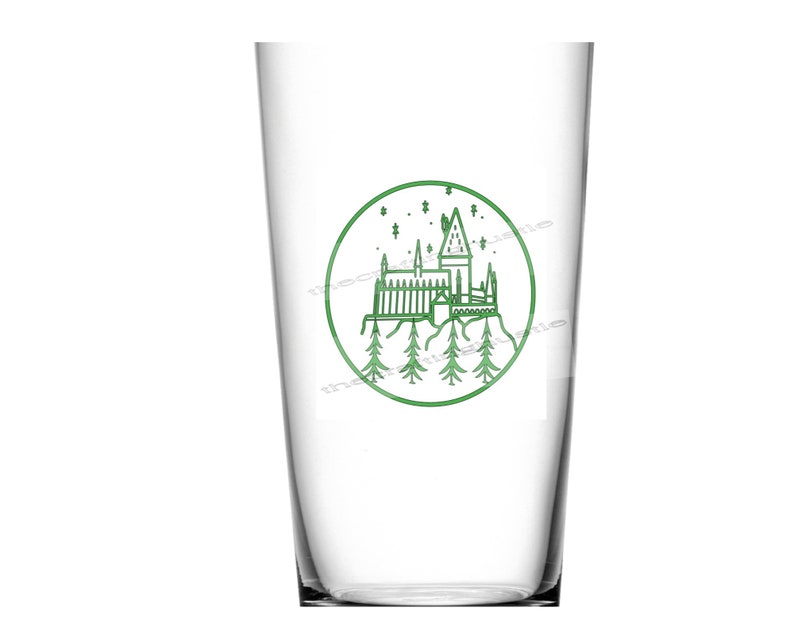 May include: A clear glass cup with a green outline of Hogwarts castle and stars in a circle on the front.