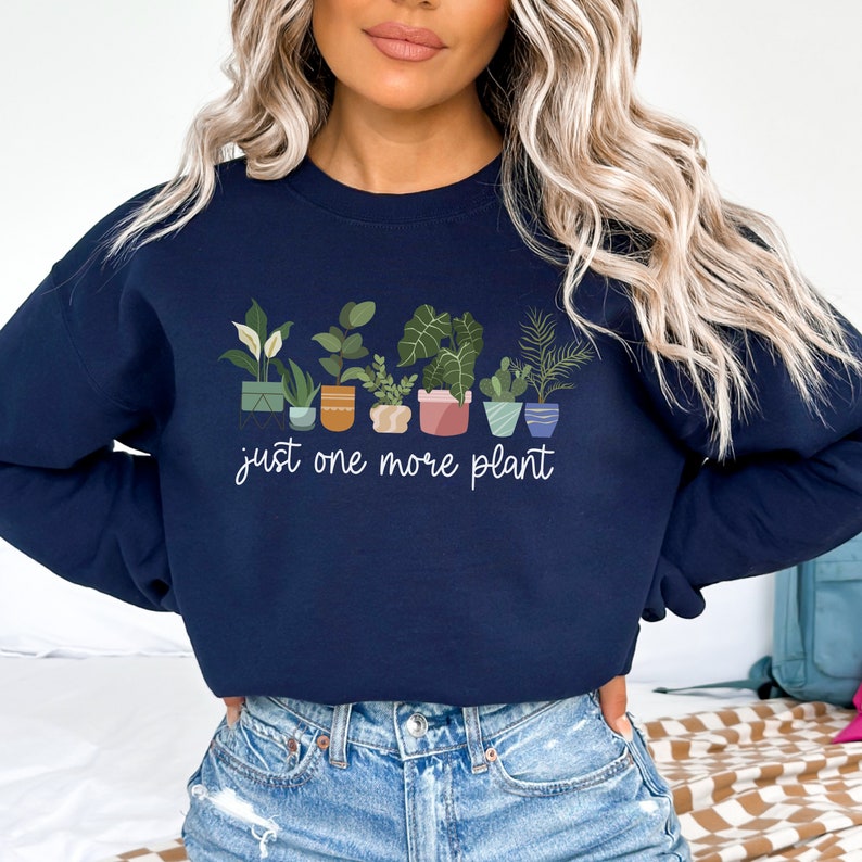 May include: Navy blue sweatshirt with a graphic of potted plants and the text "just one more plant".