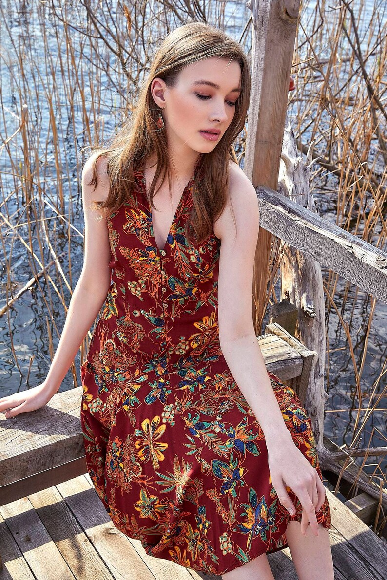 Floral pattern summer dress with halter back style. It V-Neck with coconut buttons, and it looks so stylish. Bohemian style floral pattern dress