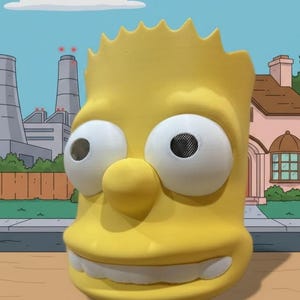 May include: A yellow Bart Simpson mask with large white eyes and mesh inserts. The mask features a large nose, a wide grin with white teeth, and spiky hair. The background shows a cartoon cityscape with a blue sky and industrial buildings.