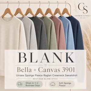 May include: A collection of seven long-sleeve crewneck sweatshirts hanging on wooden hangers, displayed in a row. The colors include cream, light gray, dark gray, sage green, dusty rose, light blue, and navy blue. Text reads BLANK Bella + Canvas 3901.