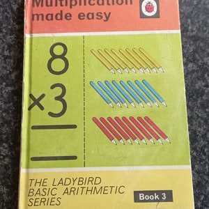 May include: A vintage Ladybird book titled "Multiplication made easy" with a red ladybug logo. The book cover features a visual representation of the multiplication problem 8 x 3 using coloured pencils.