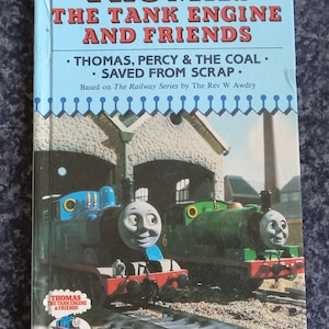 May include: A blue and green children's book titled "Thomas the Tank Engine and Friends" with a picture of two toy trains on the cover. The book is based on the Railway Series by The Rev W Awdry.