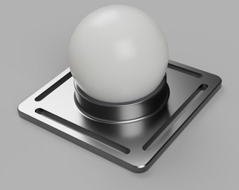 May include: A white sphere sits atop a silver-colored, square base with a circular support. The base has a geometric design with cut-out lines. The overall design is modern and minimalist.