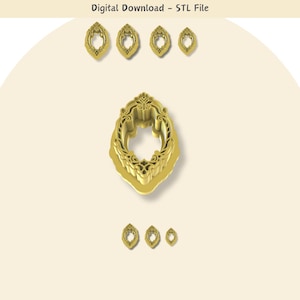 May include: A set of five gold-colored metal cookie cutters in the shape of an ornate oval frame. The cutters are arranged in a row, with the largest cutter in the center and the smallest cutters on either end.