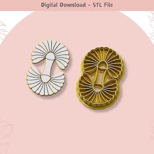 Könnte beinhalten: Zwei 3D-gedruckte Ausstecher, einer weiß und einer goldfarben, in Form einer Blume mit mehreren Blütenblattschichten.