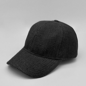 May include: A black baseball cap made of a woven fabric. The cap has a curved brim and a structured crown.