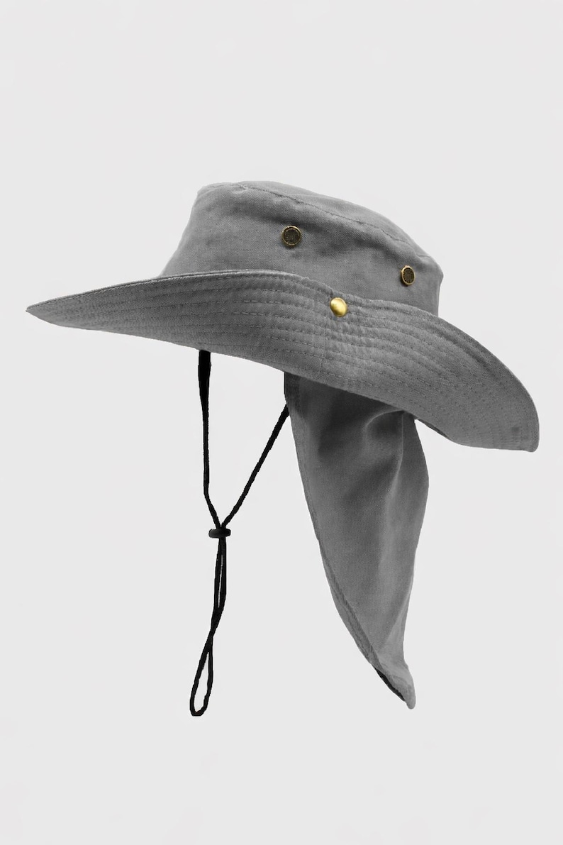 May include: Gray sun hat with a wide brim and a neck flap. The hat features a black chin strap with an adjustable toggle. Gold-colored rivets secure the hat's crown. This hat is designed for sun protection.