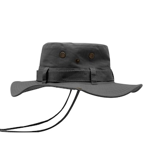 May include: A gray cotton bucket hat with a brown strap and a drawstring. The hat has a wide brim and a flat crown.