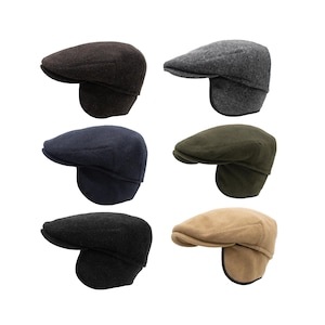 May include: Six different colored tweed newsboy caps with ear flaps. The caps are in brown, gray, navy blue, green, beige, and black.